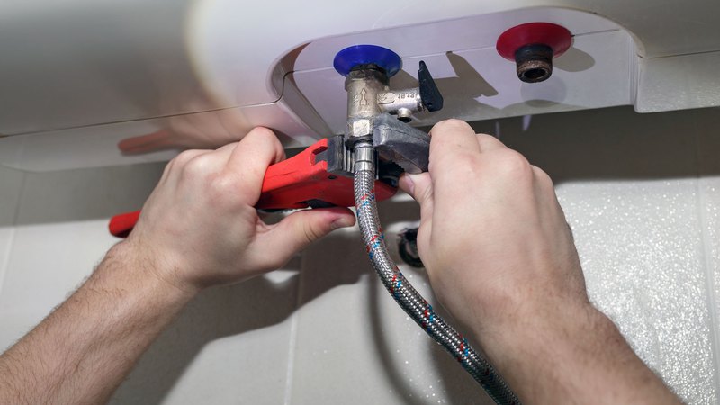 water heater service specialist adjusting settings on a water heater